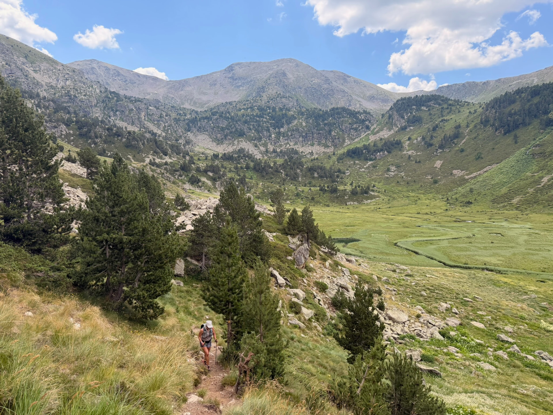 Runners crossing a high valley trail in Andorra